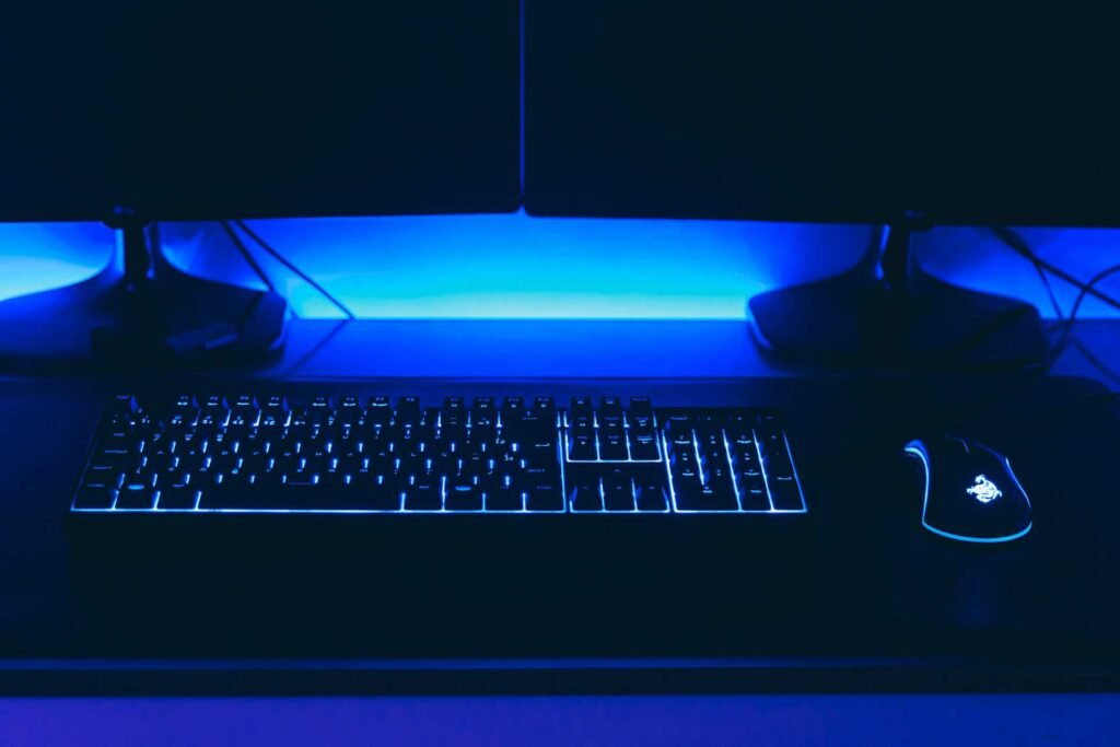 A simple multi monitor gaming setup with blue lights.