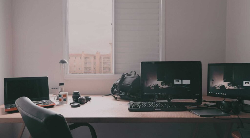 A home office setup with multiple monitors and devices connected.