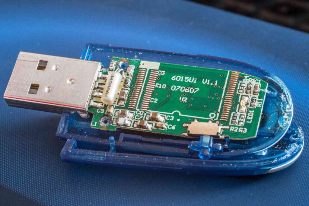 An opened blue usb flash drive on a blue textile.