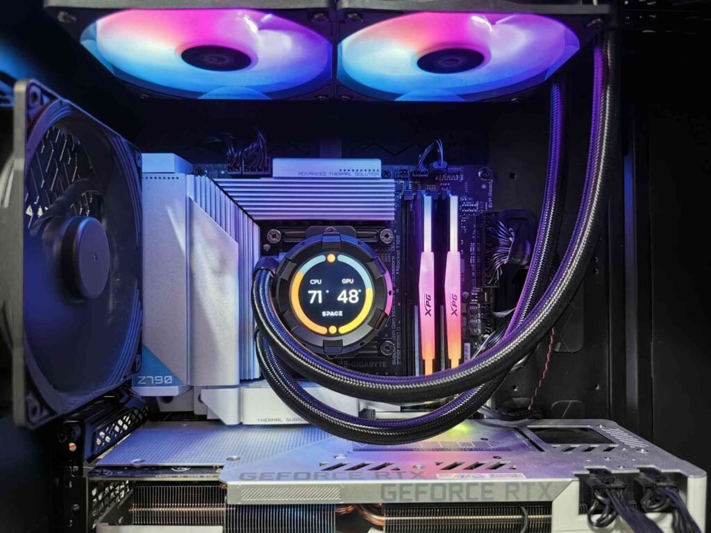 A computer case with an extensive cooling system showing gpu and cpu temperature.