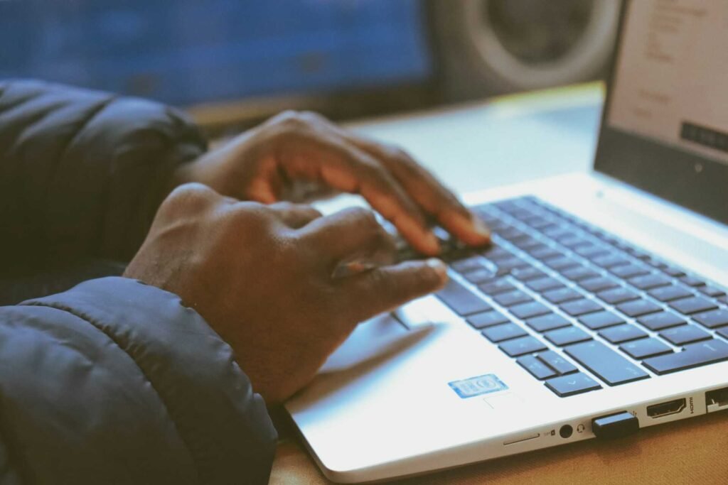 A person typing on a laptop.