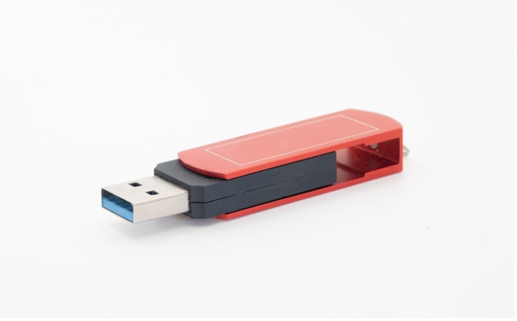 A red and black usb flash drive.