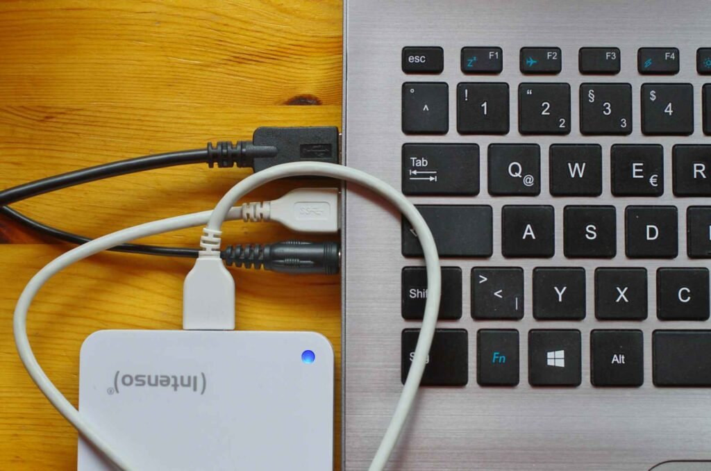 Multiple USB devices and headphones plugged into a laptop.
