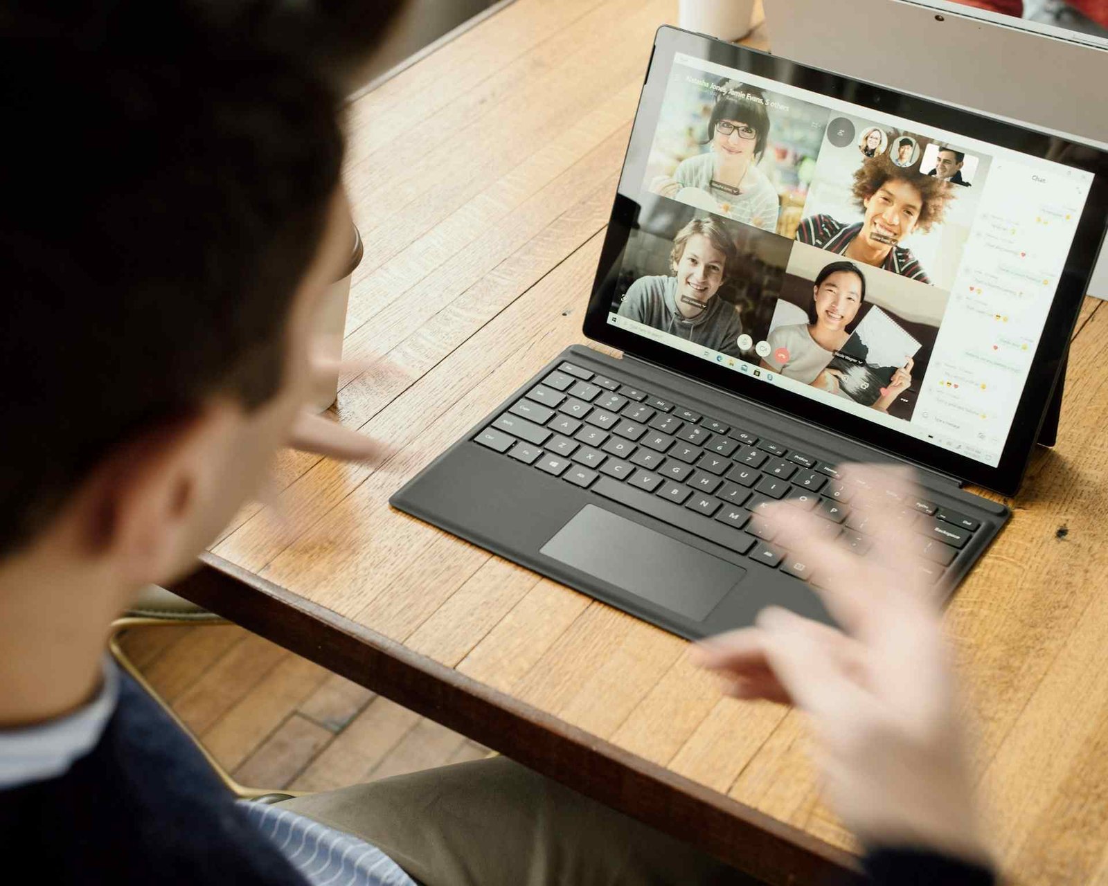 A person in a zoom call with 4 other people.