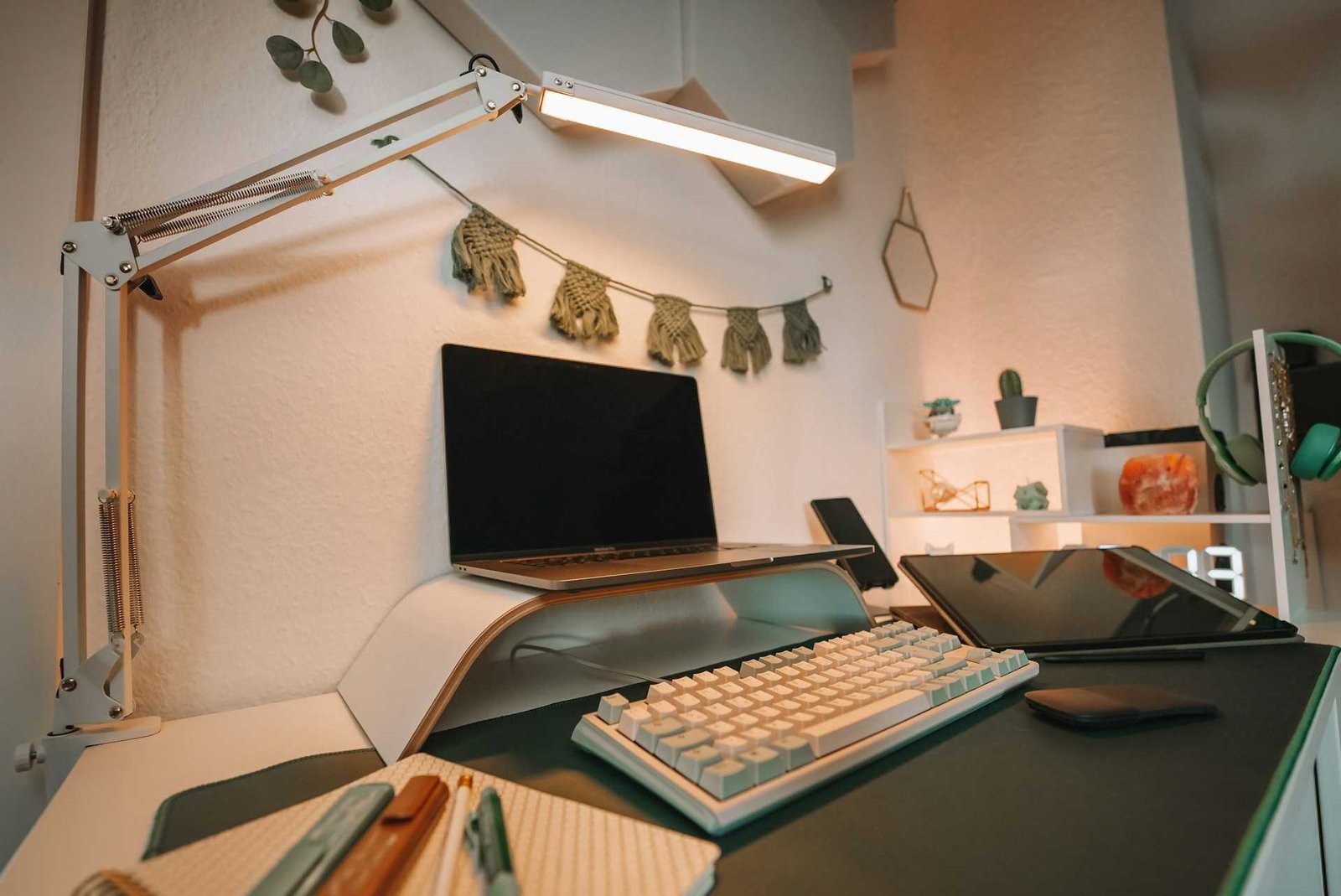 A clip on led desk light lighting a workspace.