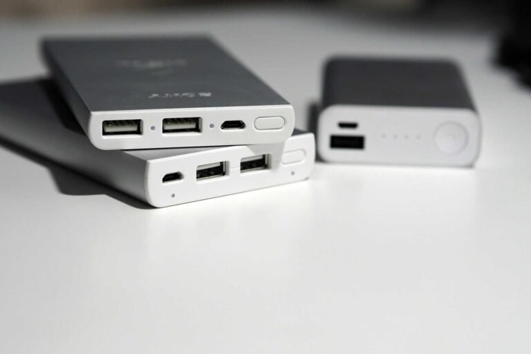 3 power bank lying on a white desk on top of each other.