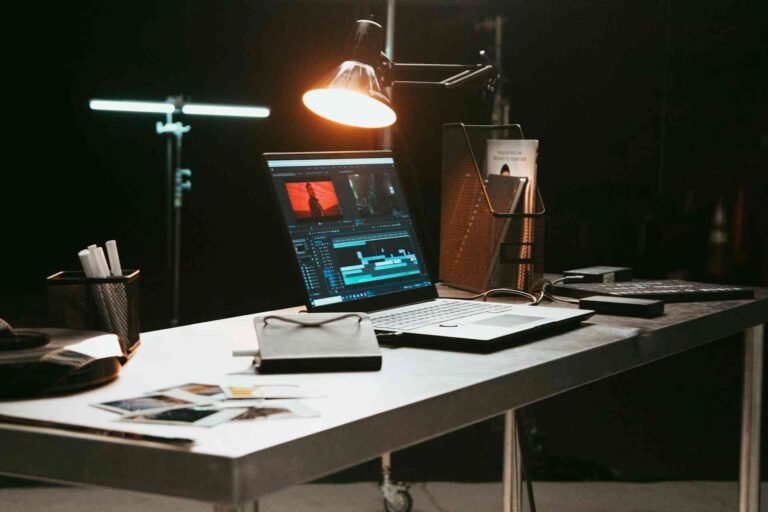 A desk lamp positioned directly over a laptop.