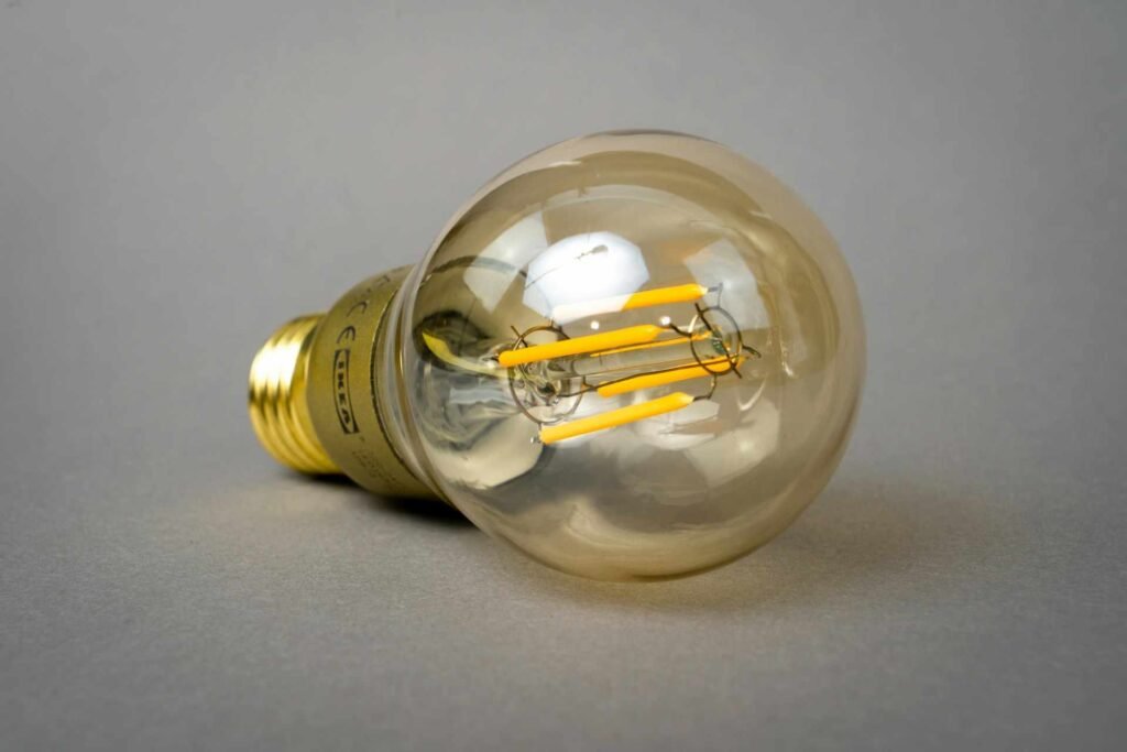 An LED light bulb lying on a white surface.