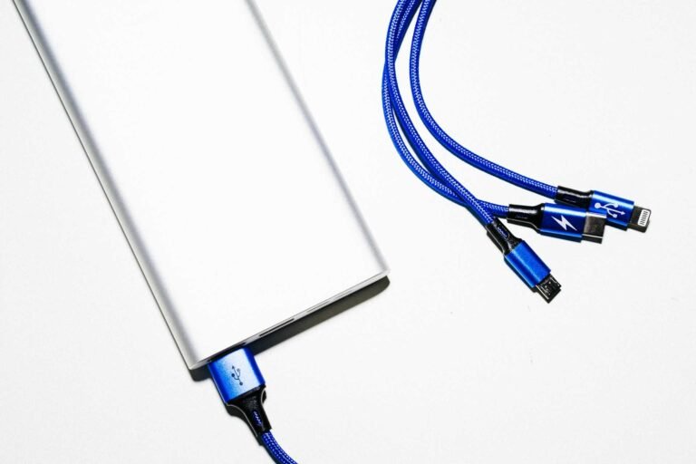 Thunderbolt and other usb cables connected to a device on white background.