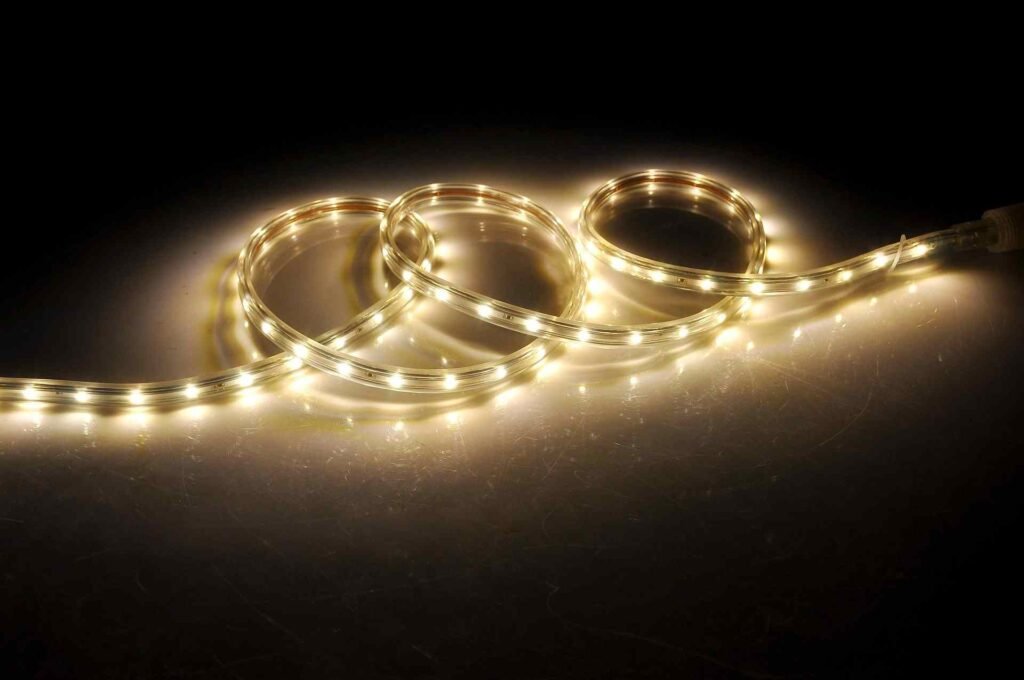 Turned on LED strip lights lying on the ground in the dark.