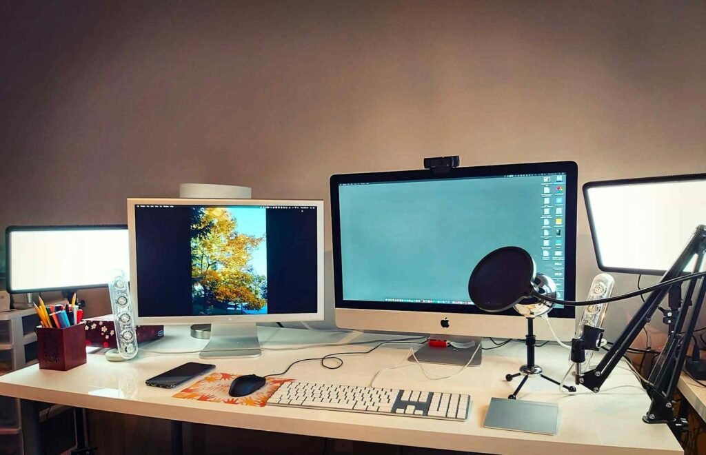 A cool workspace led light next to 2 monitors.