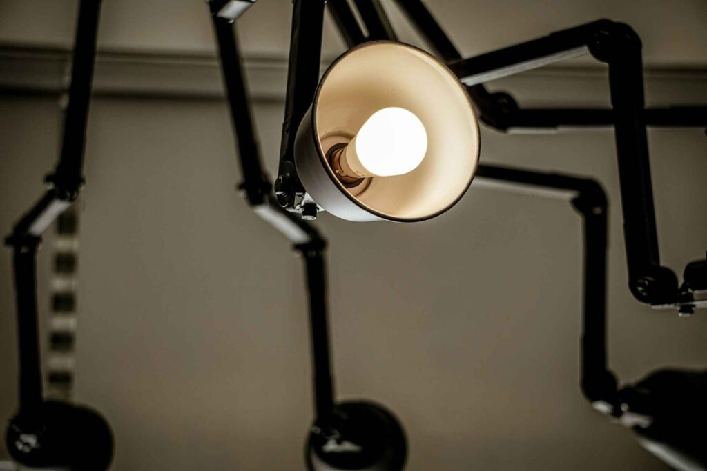 Many white LED desk lamp arms pointing in different directions.