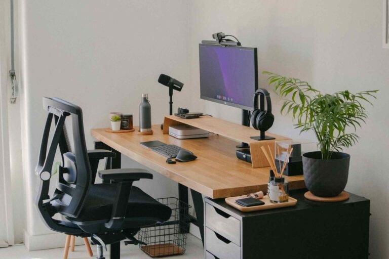 An office chair in front of a desk with a large cushion.