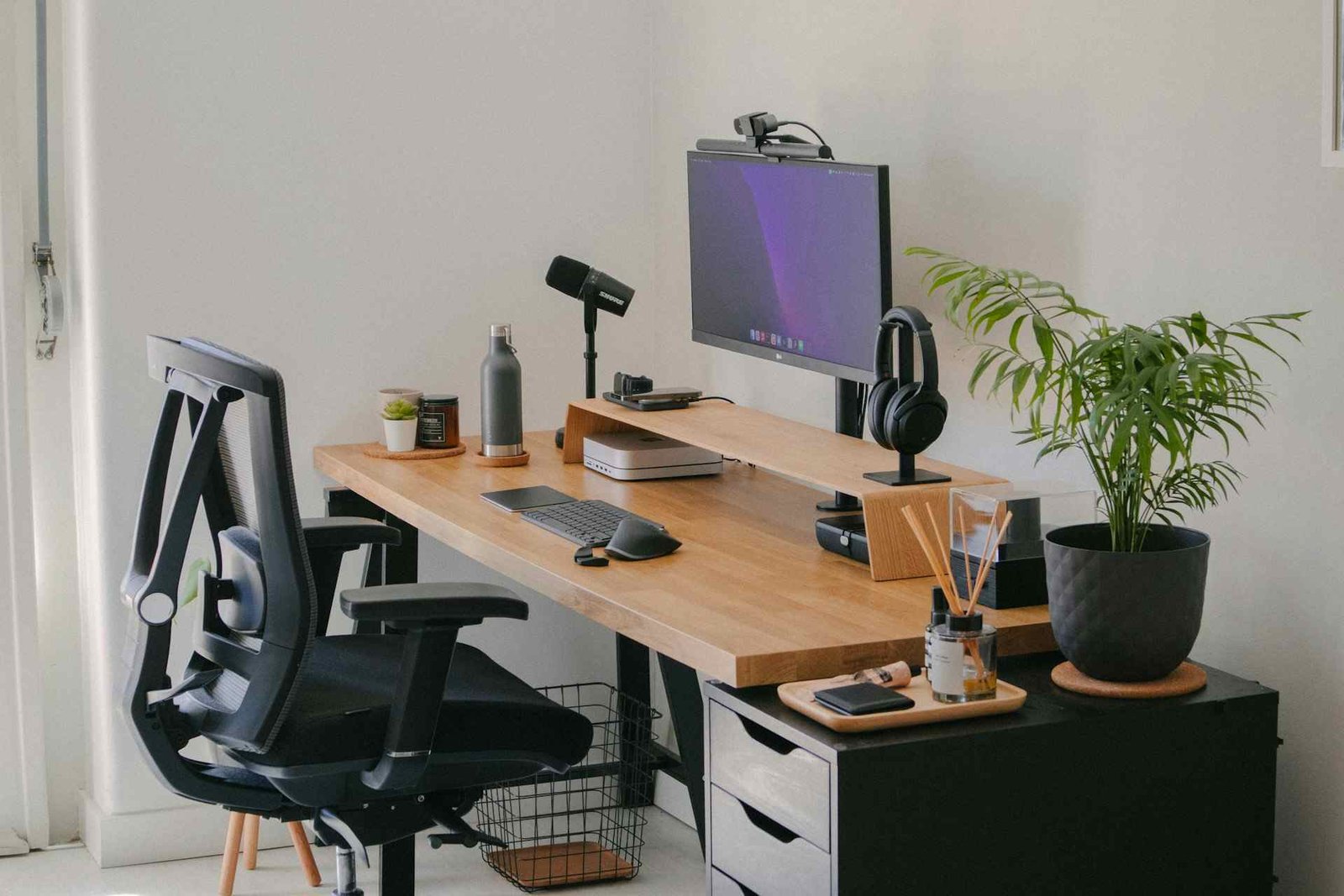 An office chair in front of a desk with a large cushion.