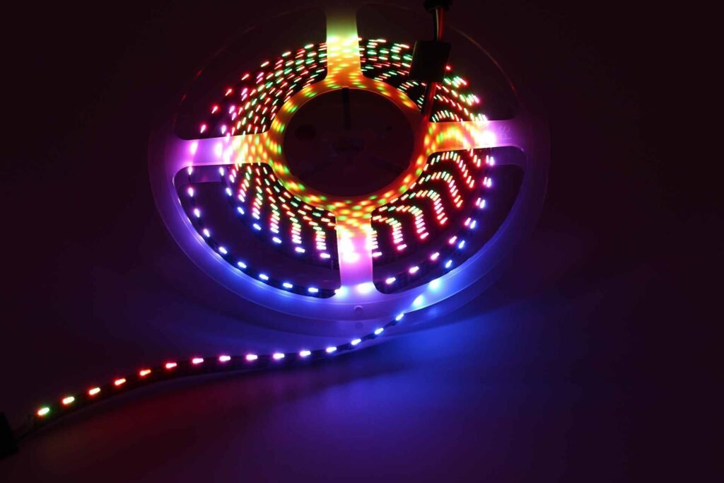 A dimmed led strip light on a roll in the dark.