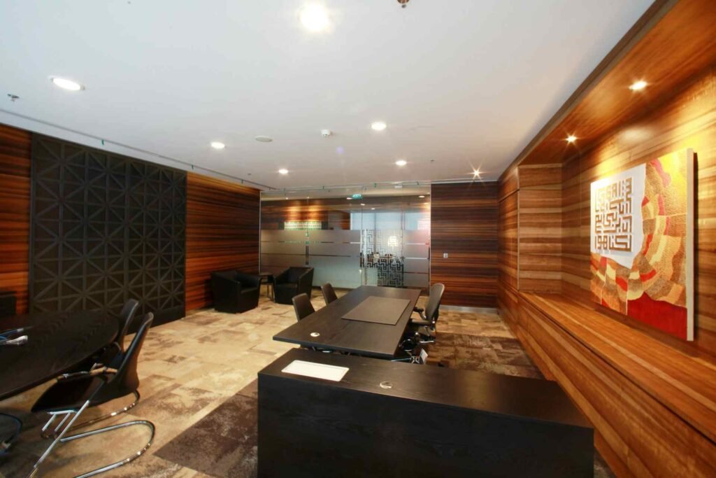 A modern and warm looking office room with wooden walls.