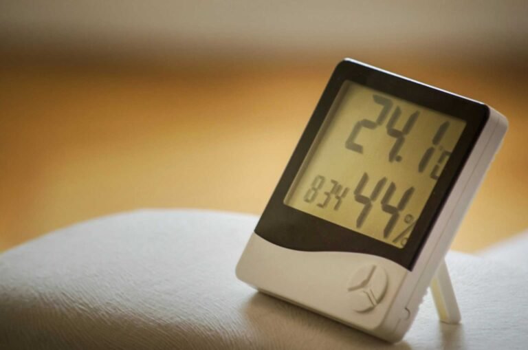 A hygrometer showing the temperature and humidity of a room.