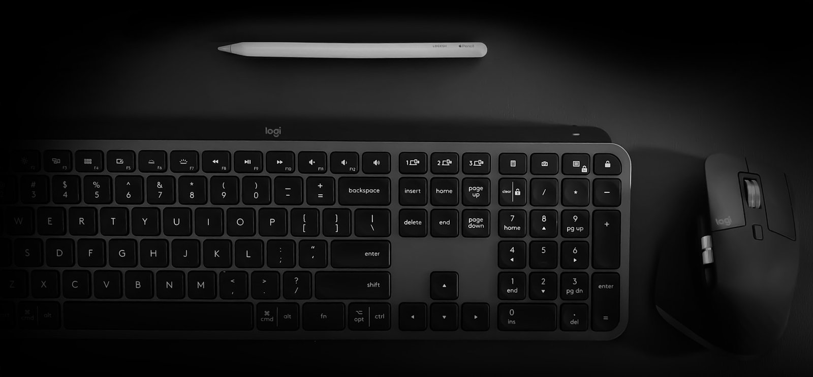A black logitech mouse and keyboard wireless multi device combo.