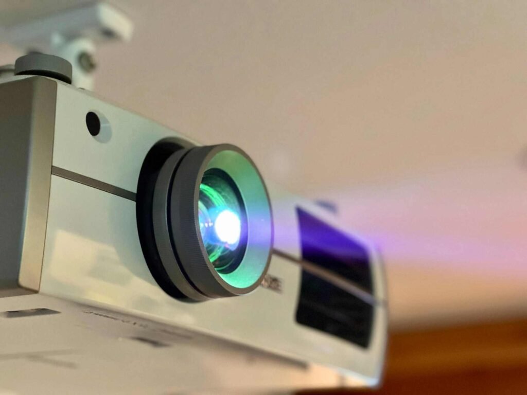 A close up of a ceiling projector lens turned on.