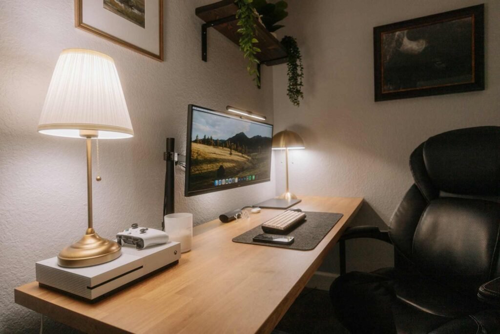 A small home office space with two lights and a leather chair.