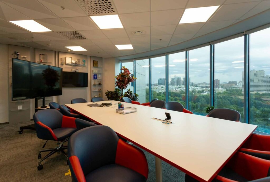 A modern meeting room with a TV and nice view.