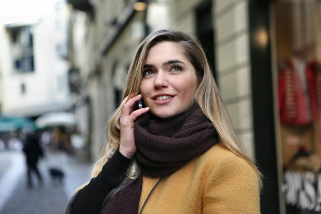 A woman on a phone call with a large scarf.