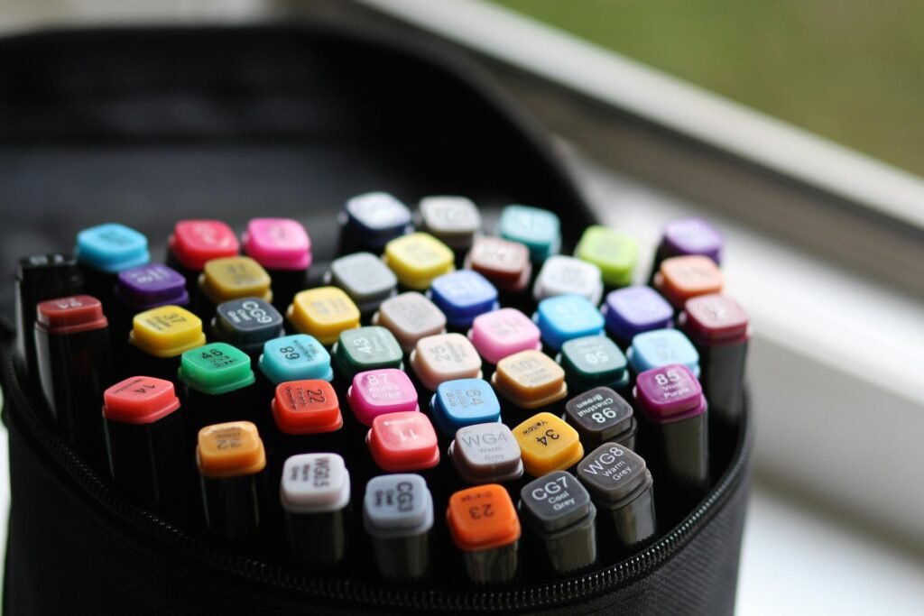 An assortment of many different colored markers in a pouch.