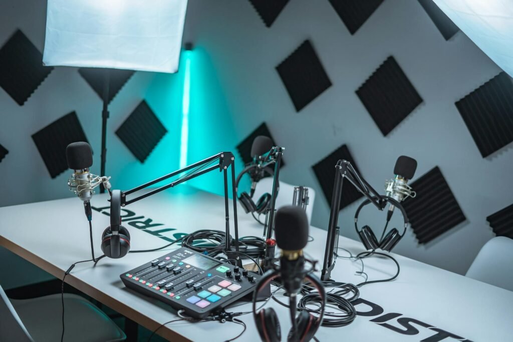 A podcast setup with multiple microphones and foam panels on the wall.